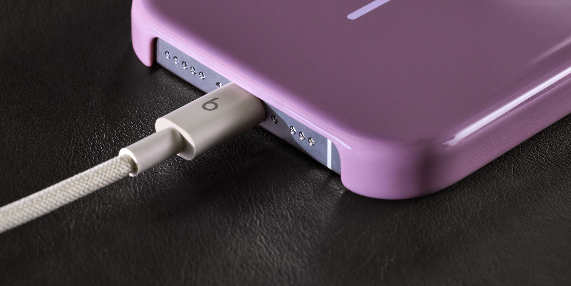 Person plugging in the Beats USB-A to USB-C Woven Cable into an iPhone.