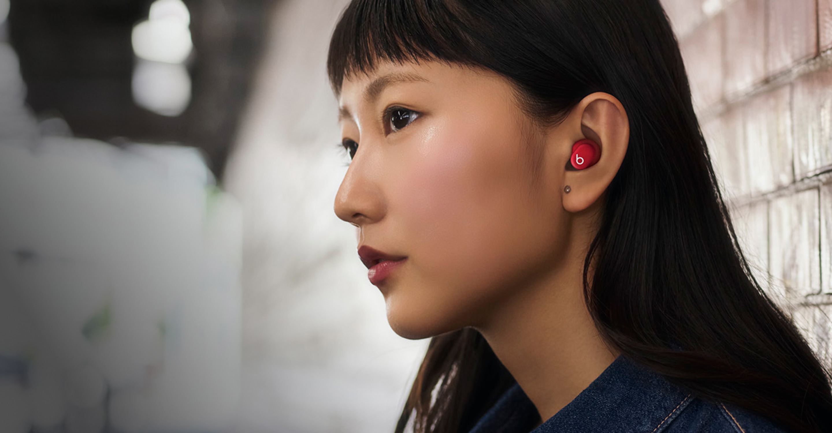 Beats Solo Budsのトランスペアレントレッドを装着した人物