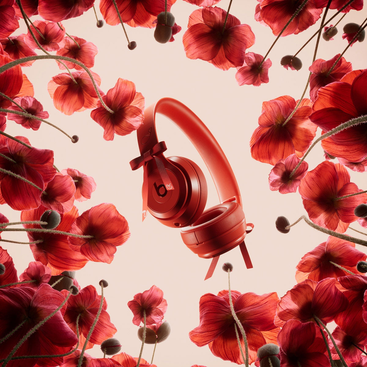 Beats Solo 4 – JENNIE Special Edition headphones in Ruby Red surrounded by red poppy flowers.
